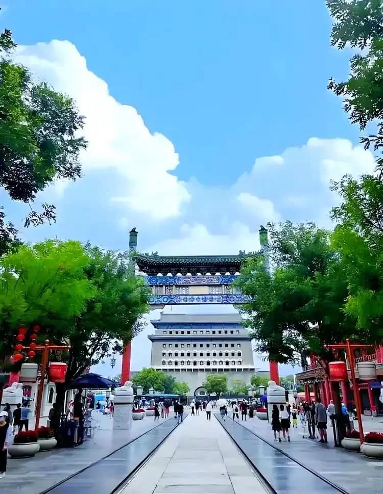 Qianmen pedestrian street with tram tracks and a traditional gateway