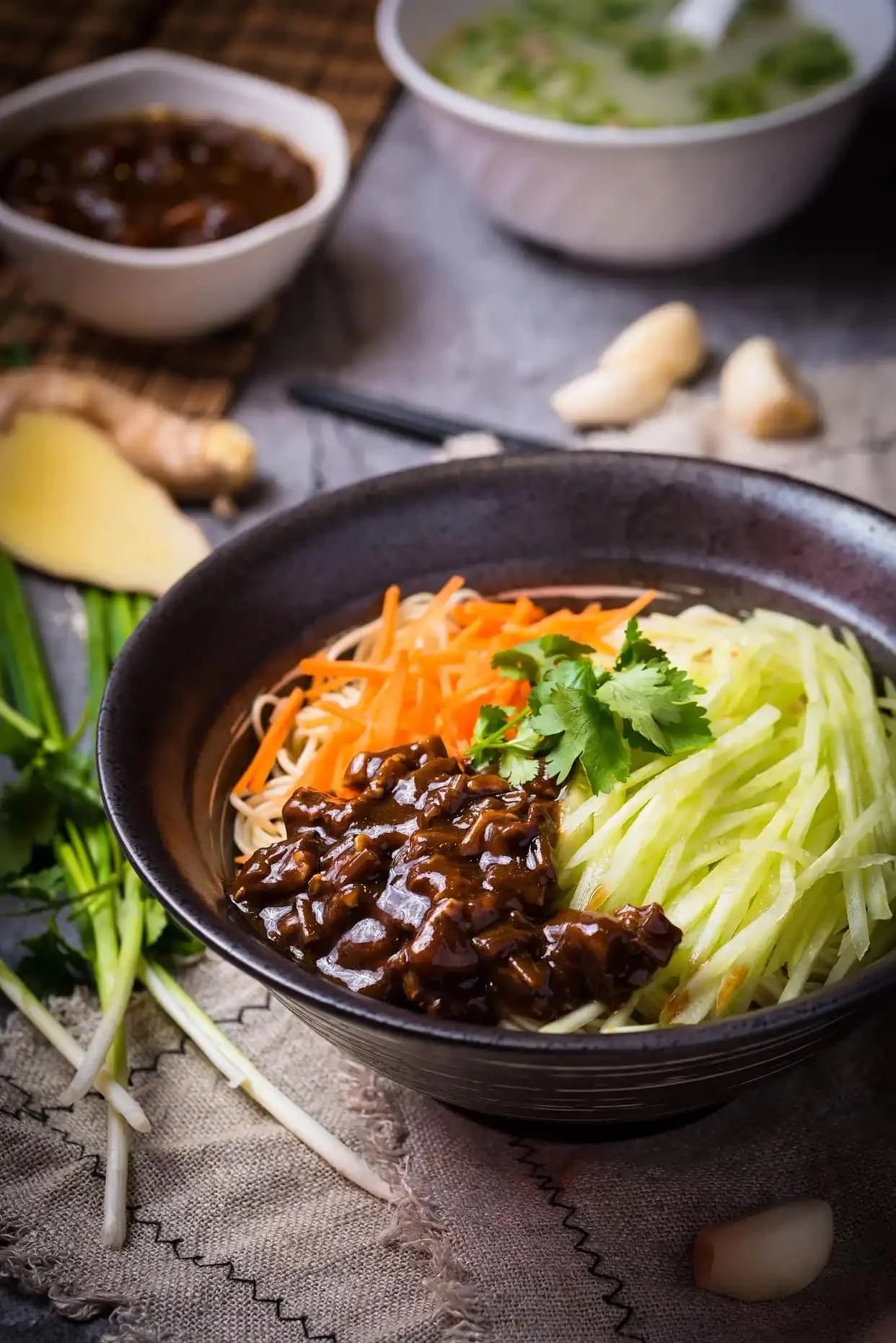 Noodles topped with dark soybean-paste sauce, shredded cucumber and carrot