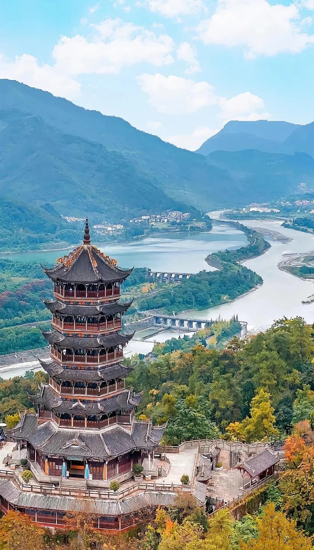 A tiered pavilion overlooking the river channels and wooded hills at Dujiangyan.