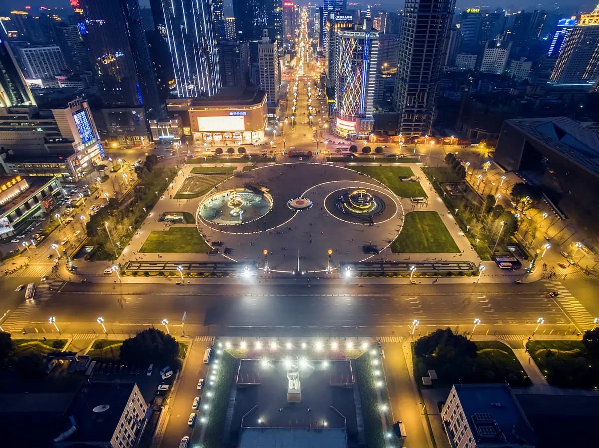 An elevated night view of Tianfu Square, its illuminated circular features and surrounding streets.