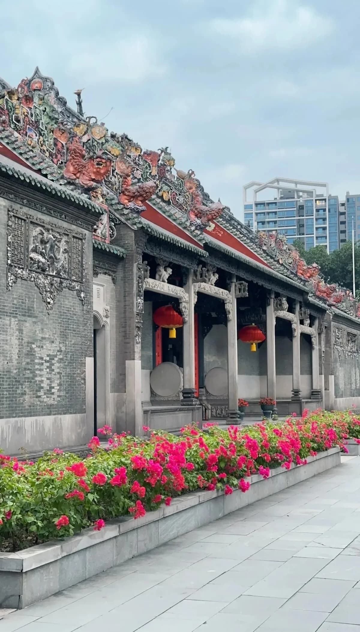 Carved roof decorations, stone columns and red lanterns at Chen Clan Academy.