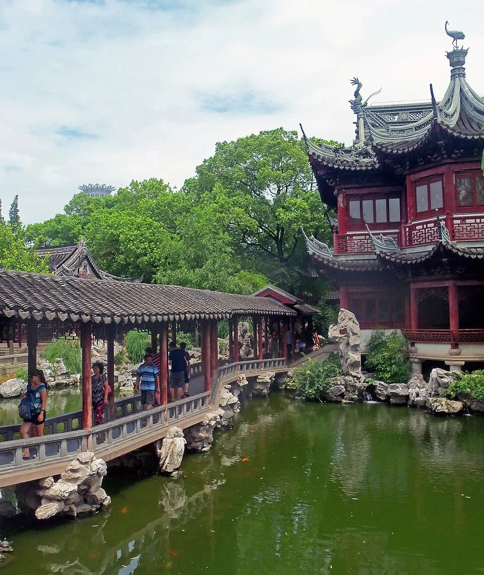 Covered walkway and traditional pavilion beside a pond inside Yu Garden.