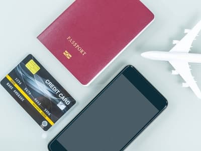 Passport, payment cards and a smartphone arranged as preparation for setting up WeChat Pay